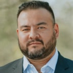 Ian Bradley, head of operations and technology at Breakout Finance, standing in a suit outdoors