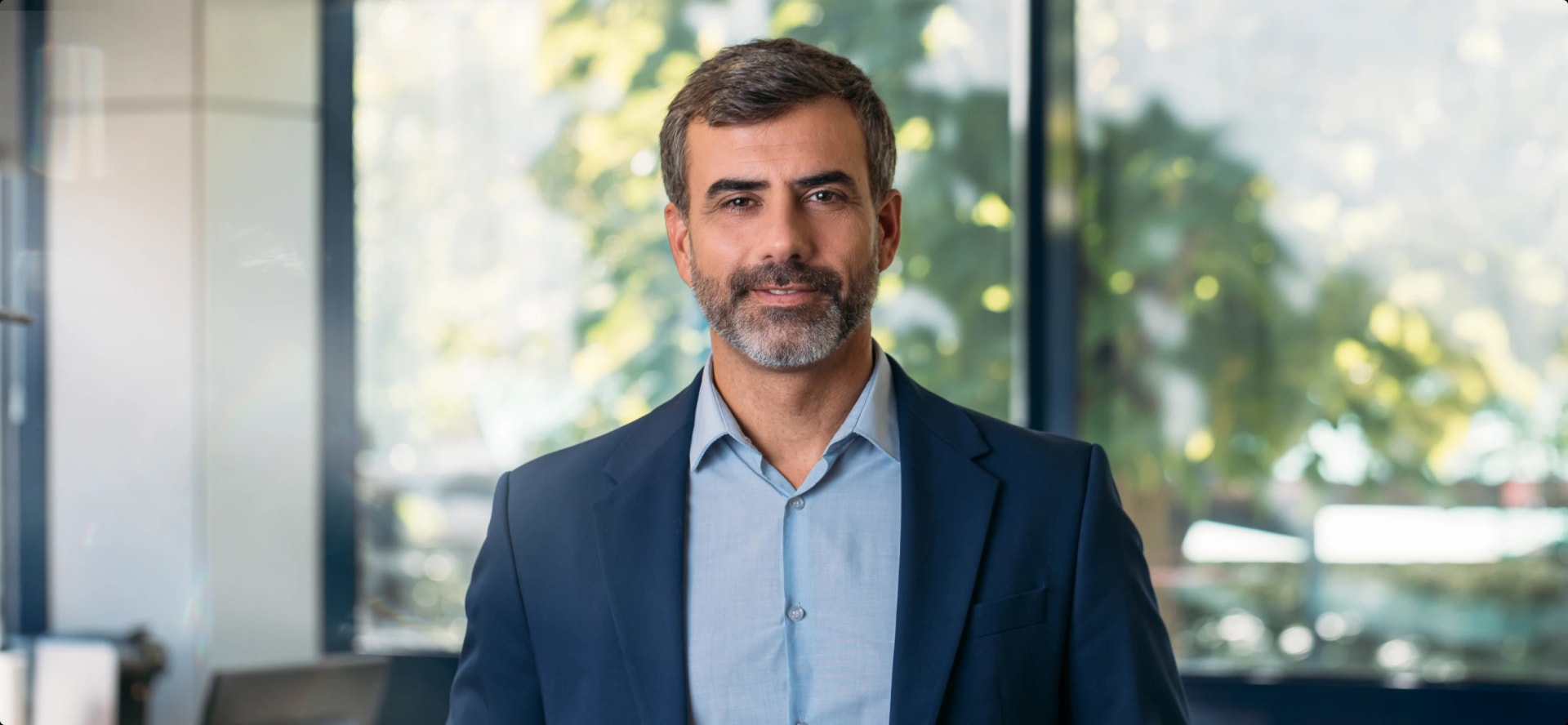 middle-aged man in blue suit standing in a conference room